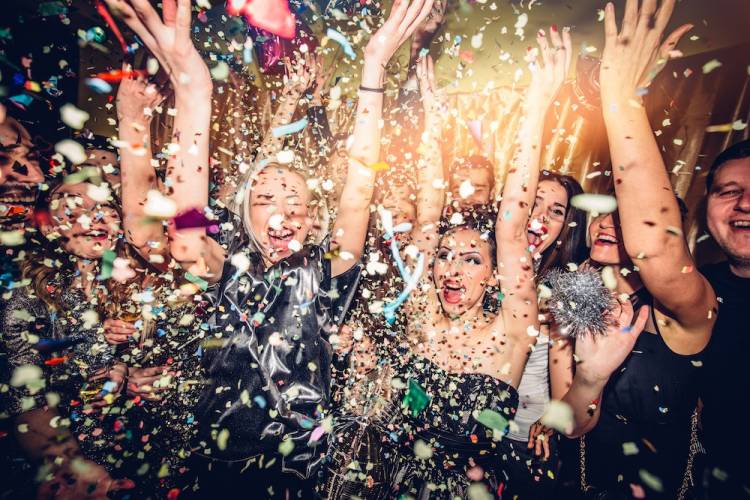 confetti falling on people at new year's eve party